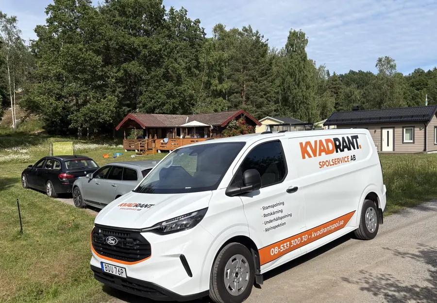 Kvadrants spolbil framför fritidshus i skogsbryn vid spolning av ett BDT-avlopp